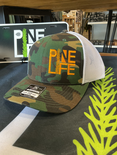 Pine Life Trucker Snapback Hat - Camo with orange stitch